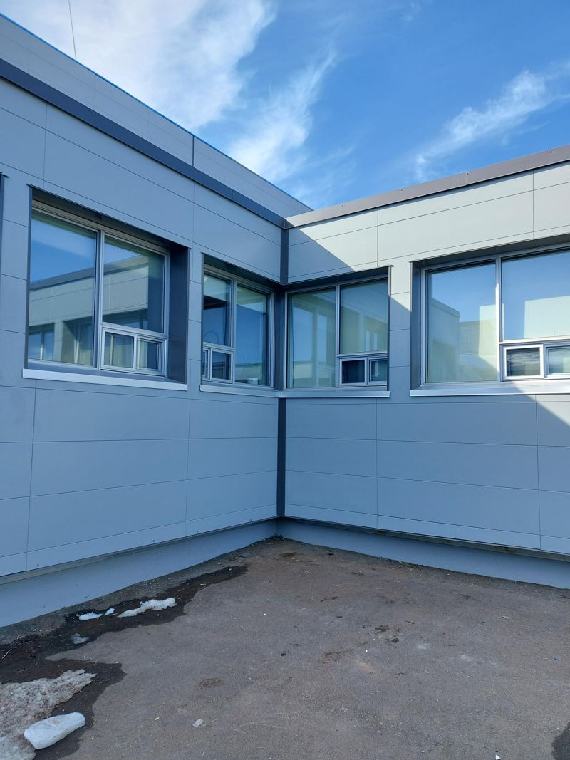 New panel cladding and windows at an inside corner