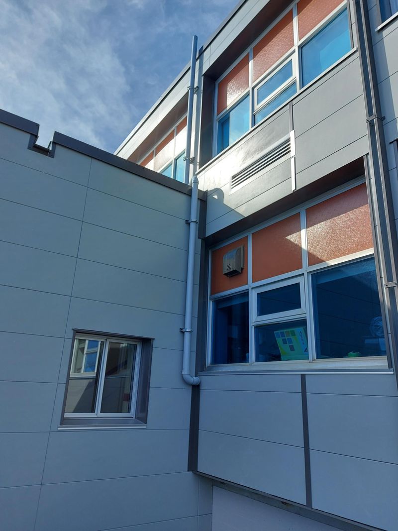 Two-storey clad wall with spandrel panels