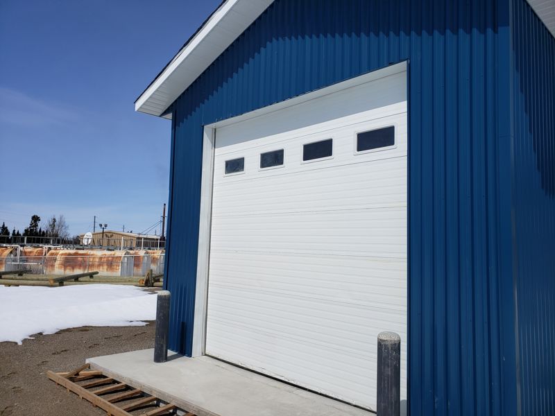 Large garage overhead door with bollards